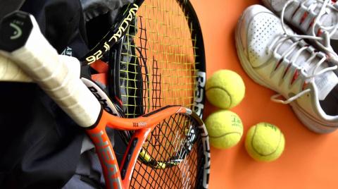 Tennis rackets, tennis balls, and sneakers